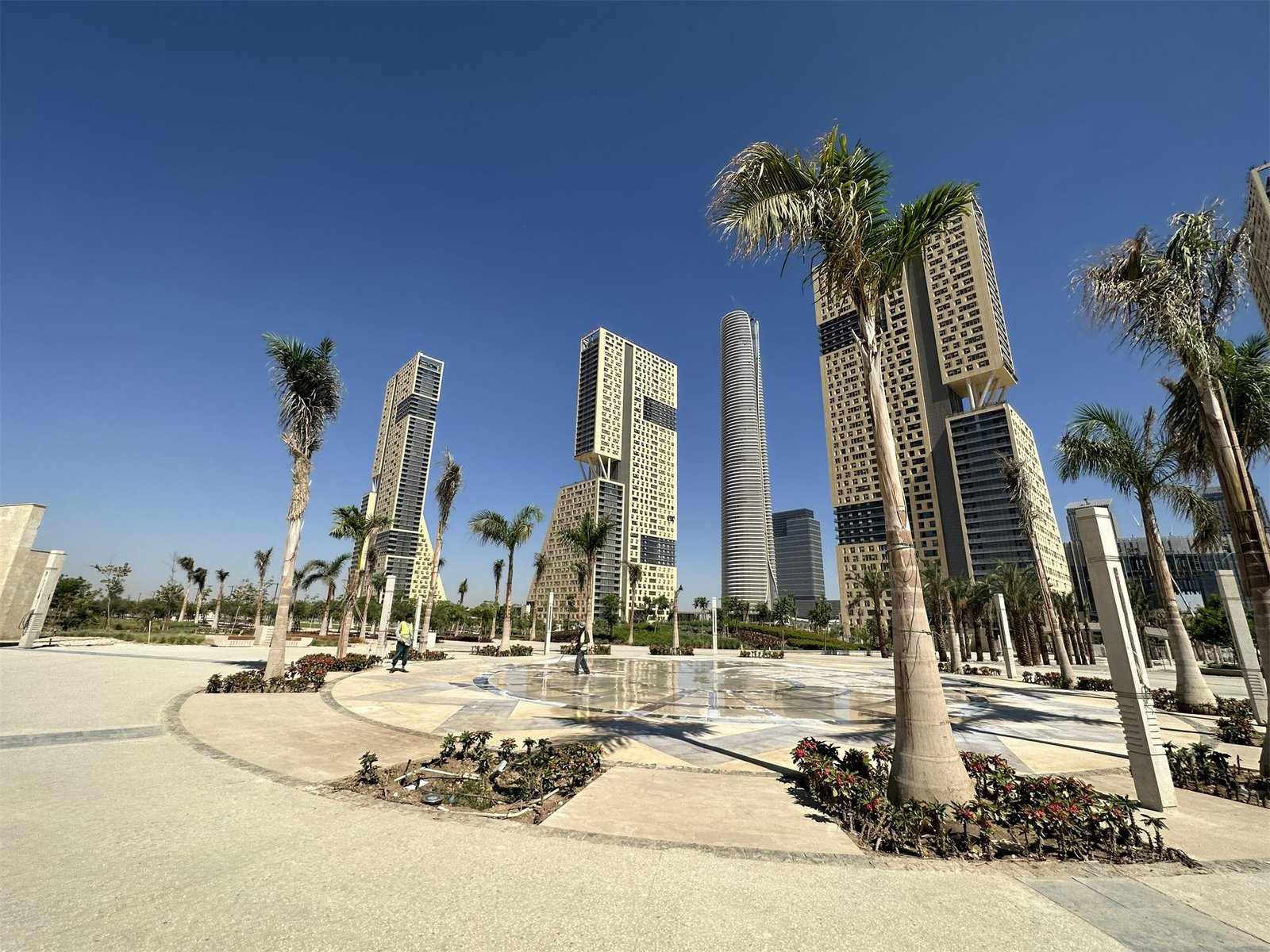 Dry-deck entrance fountain among towers