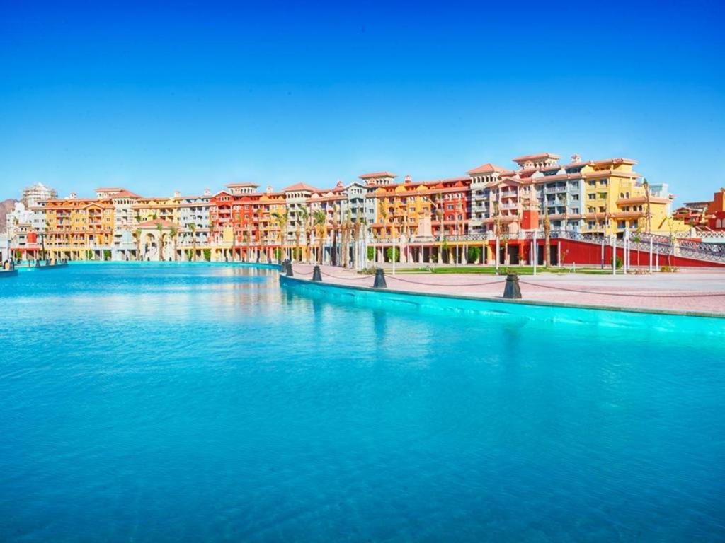 Porto Sharm lagoon at dusk with colourful buildings along the waterfront