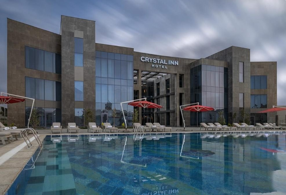 Pool in front of the Crystal Inn hotel at dusk